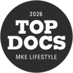 A black circular badge with the text 2026 TOP DOCS MKE LIFESTYLE in bold white letters.