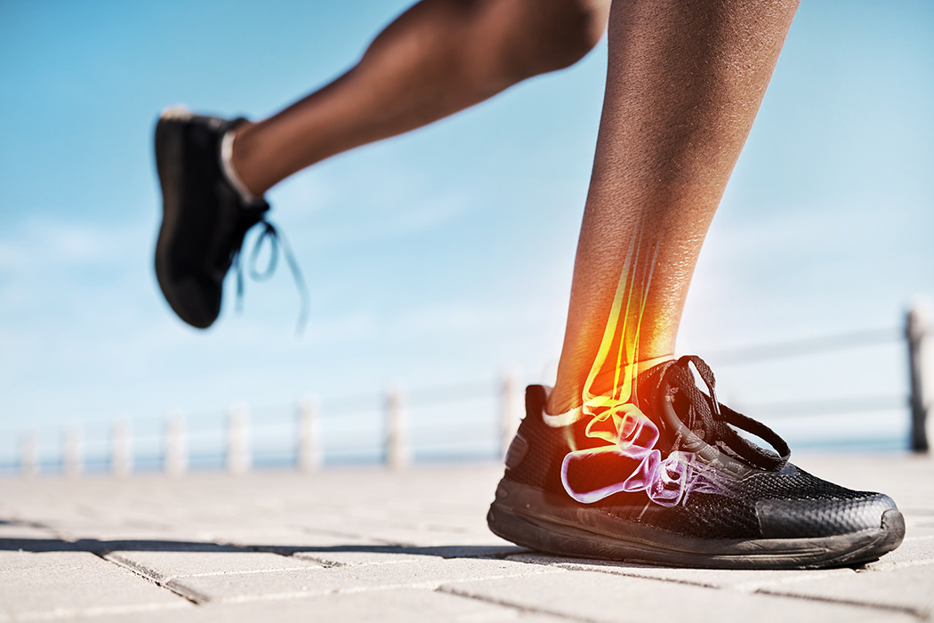 A close-up of a person’s lower legs while running outdoors in black athletic shoes. An illustration highlights the ankle bones and joint, drawing a parallel to how joint strain and even hearing loss can impact overall movement and well-being.
