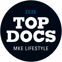 A black circular badge reading '2026 TOP DOCS MKE LIFESTYLE' in bold white and blue lettering.
